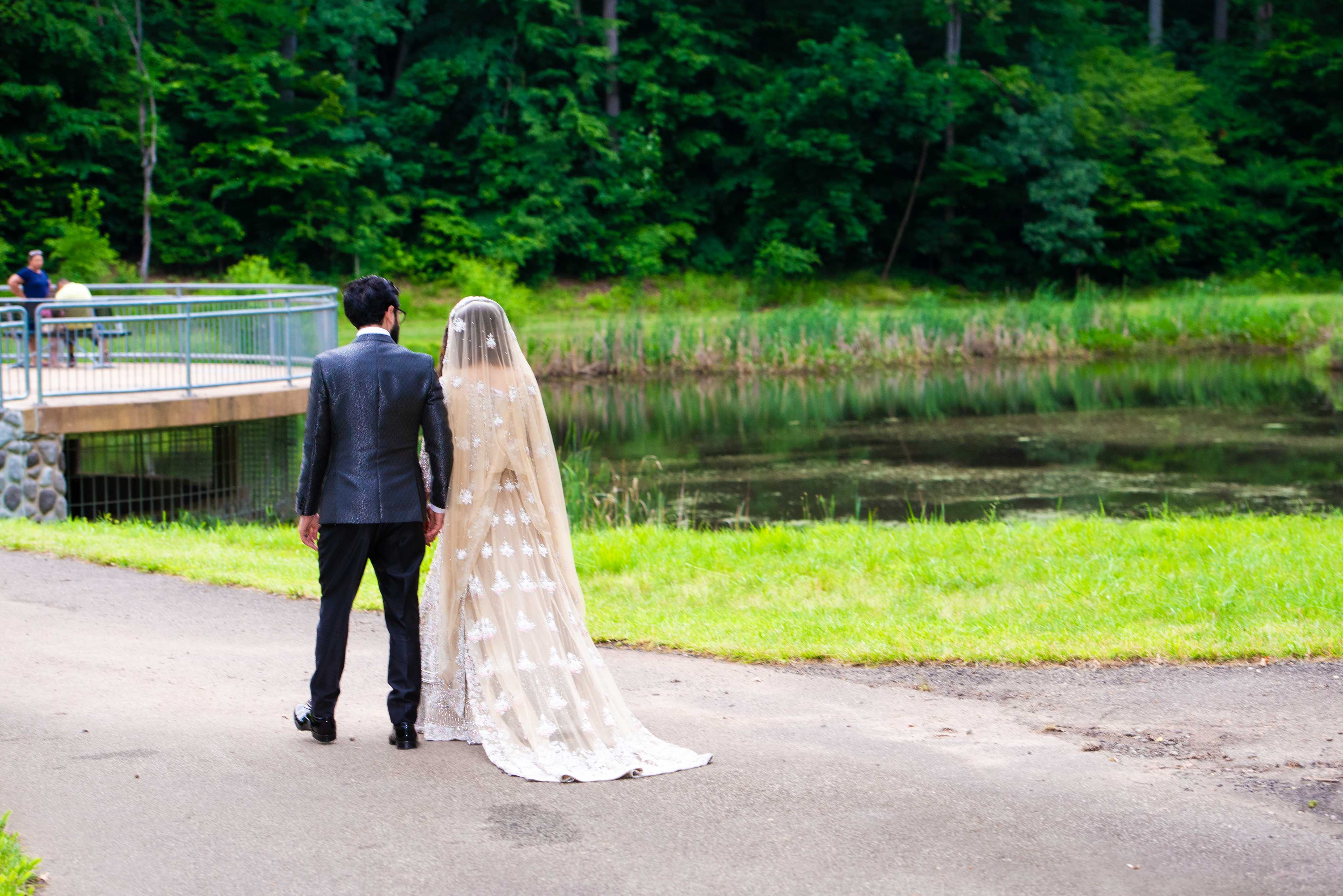 Bride and groom walking lakeside after the ceremony — Studio Meem wedding photography, DMV